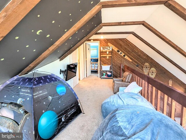 unfurnished bedroom with wood walls, carpet, and lofted ceiling