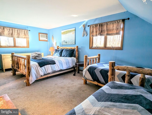 bedroom with vaulted ceiling, multiple windows, carpet, and a wall unit AC