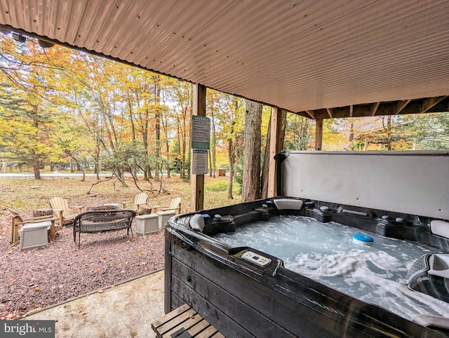 view of patio featuring an outdoor fire pit and a hot tub