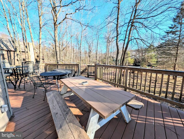 wooden terrace with outdoor dining area