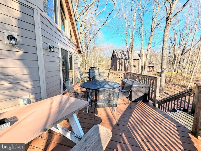 wooden deck featuring outdoor dining space