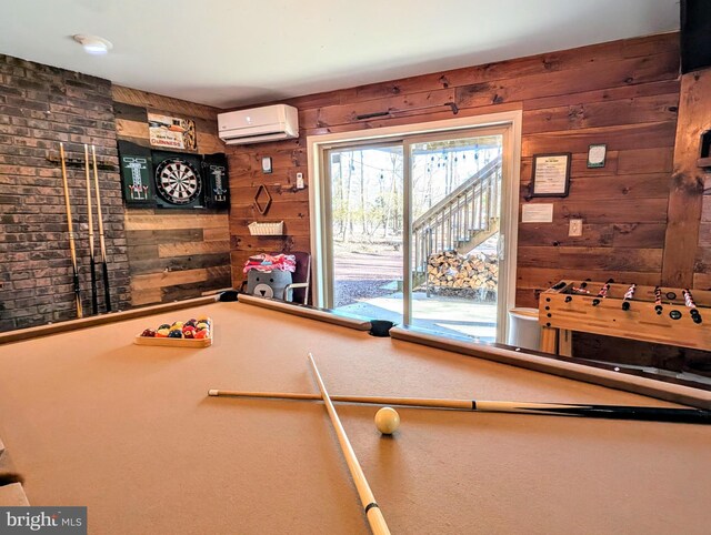 playroom featuring a wall unit AC and wood walls