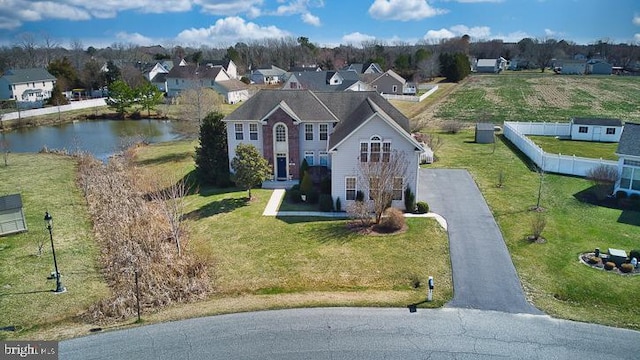 drone / aerial view with a residential view and a water view