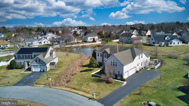 drone / aerial view featuring a residential view and a water view