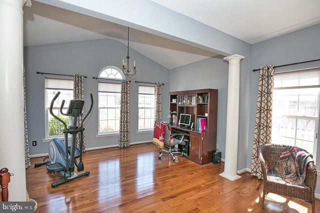 home office with baseboards, lofted ceiling, an inviting chandelier, wood finished floors, and ornate columns