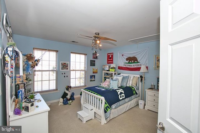 carpeted bedroom featuring visible vents, ceiling fan, attic access, and baseboards