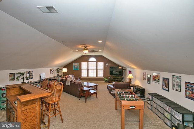 game room featuring visible vents, light colored carpet, lofted ceiling, and ceiling fan