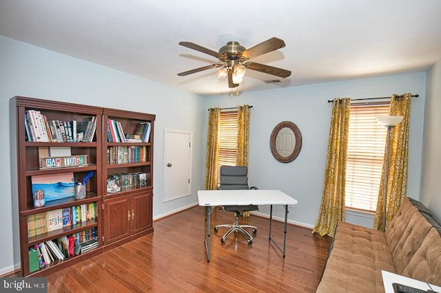 home office with baseboards, wood finished floors, and a ceiling fan