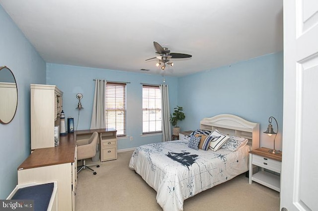 bedroom featuring visible vents, light colored carpet, baseboards, and a ceiling fan