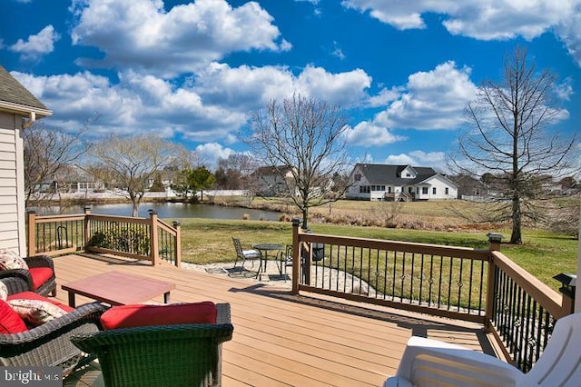 wooden deck featuring a yard and a water view