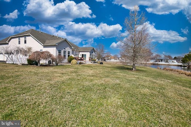 view of yard featuring a deck with water view