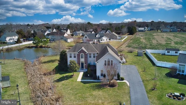 birds eye view of property with a residential view and a water view