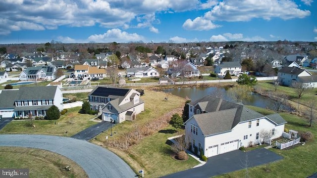 birds eye view of property with a residential view and a water view