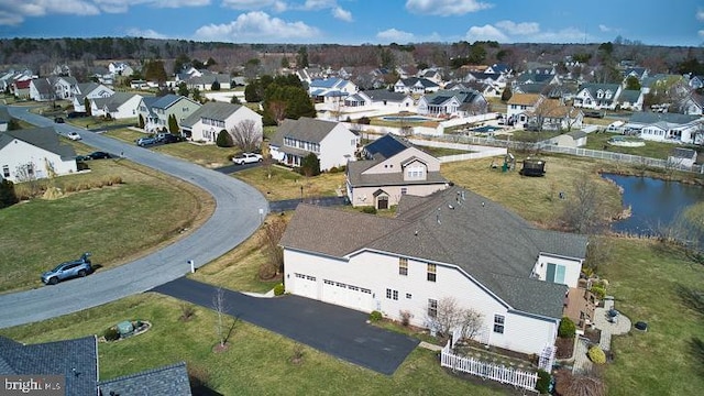 drone / aerial view with a residential view and a water view