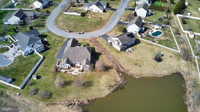 drone / aerial view featuring a residential view and a water view