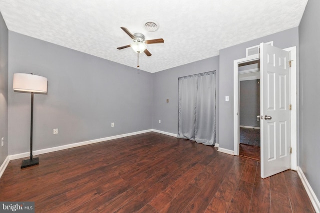 unfurnished bedroom with visible vents, baseboards, hardwood / wood-style floors, a textured ceiling, and a ceiling fan