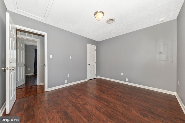 unfurnished bedroom featuring visible vents, a textured ceiling, baseboards, and wood finished floors