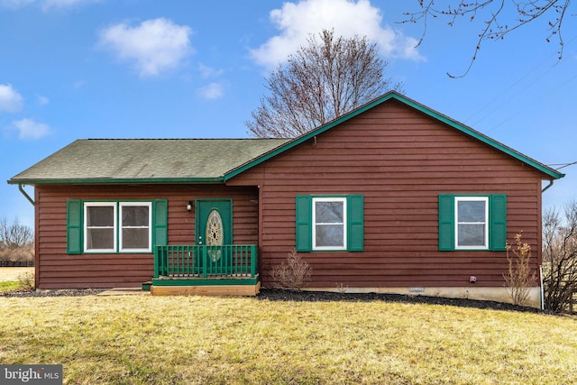 view of front of property featuring a front lawn and roof with shingles