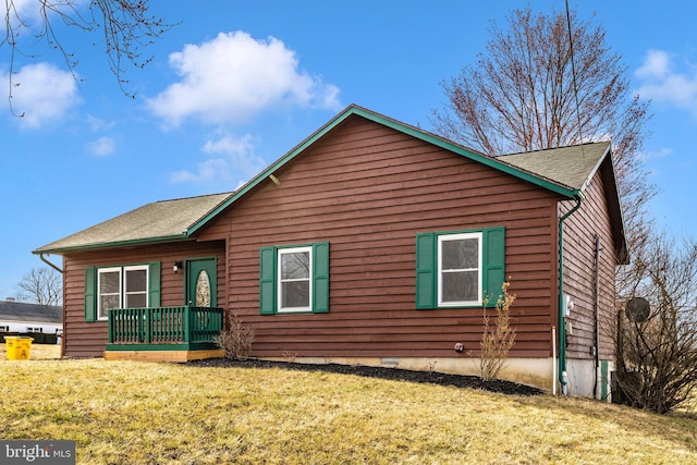 exterior space featuring a front lawn and crawl space