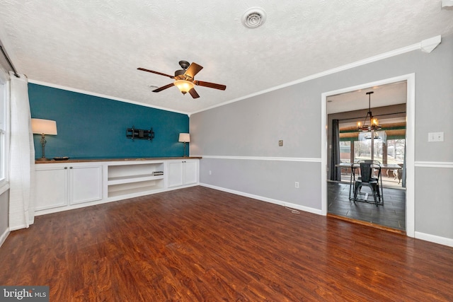 unfurnished living room with ceiling fan with notable chandelier, ornamental molding, a textured ceiling, and wood finished floors