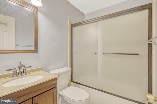 full bath featuring vanity, toilet, and enclosed tub / shower combo