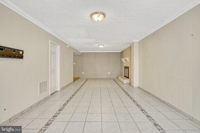 basement featuring baseboards, a textured ceiling, ornamental molding, and a fireplace