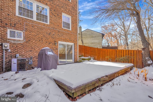 exterior space featuring brick siding and fence