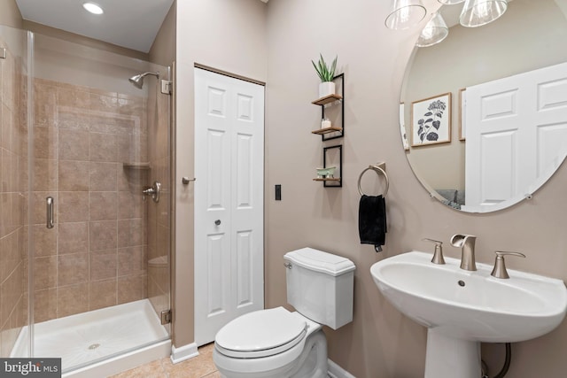 full bath with tile patterned floors, a stall shower, and toilet