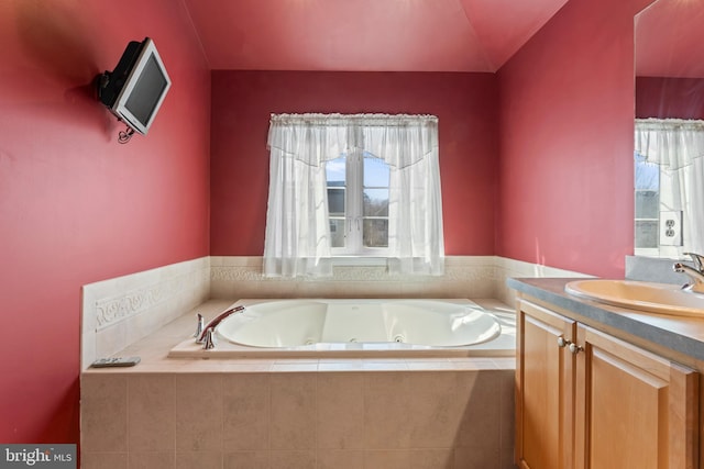 full bathroom featuring vanity and a tub with jets