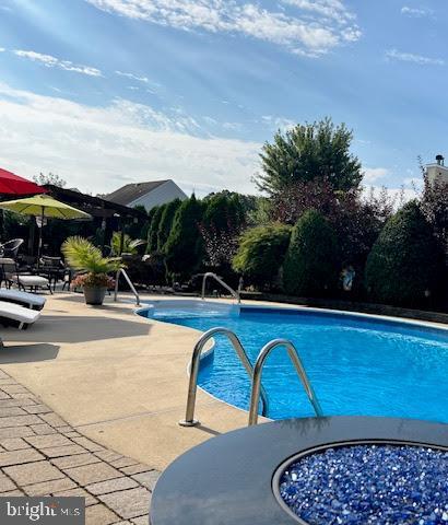 outdoor pool featuring a patio