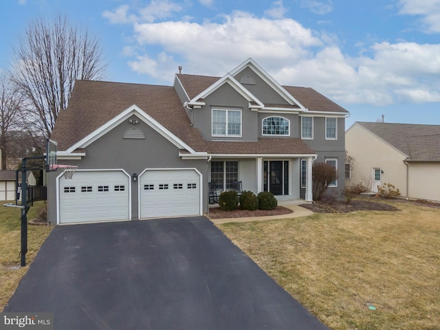 view of front facade featuring a front yard, driveway, an attached garage, a shingled roof, and stucco siding