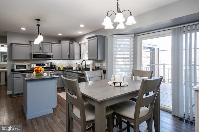 dining room featuring recessed lighting, dark wood-type flooring, and a toaster