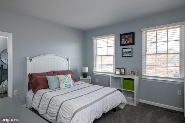 carpeted bedroom featuring visible vents and baseboards