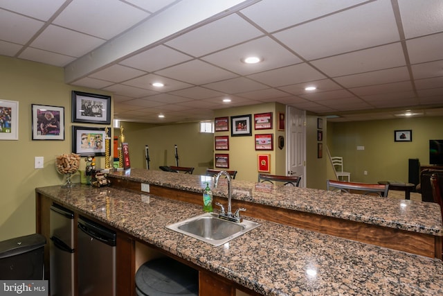 bar featuring wet bar, recessed lighting, a sink, a paneled ceiling, and stainless steel dishwasher