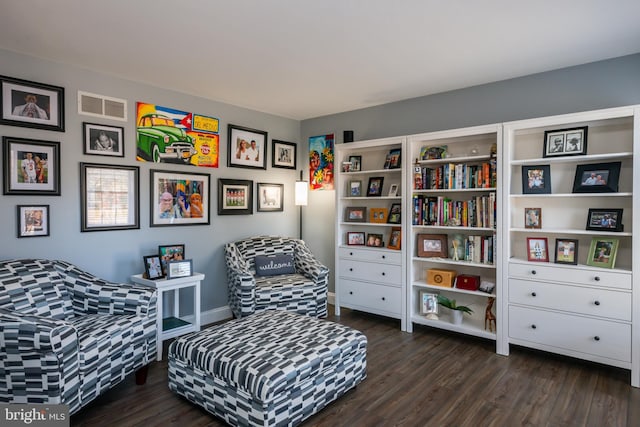 sitting room with visible vents and dark wood-style flooring