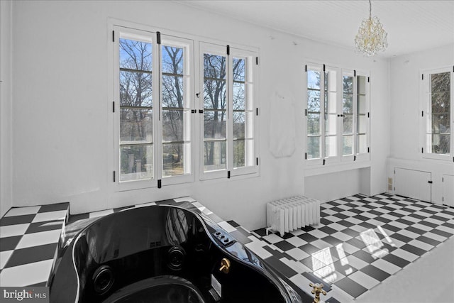 bedroom with tile patterned floors, a chandelier, and radiator heating unit