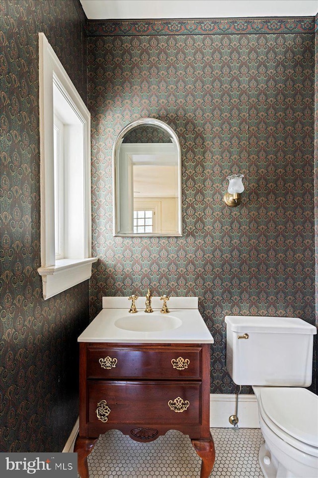 bathroom featuring wallpapered walls, toilet, vanity, and tile patterned flooring