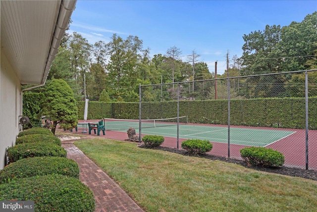 view of sport court featuring a lawn and fence