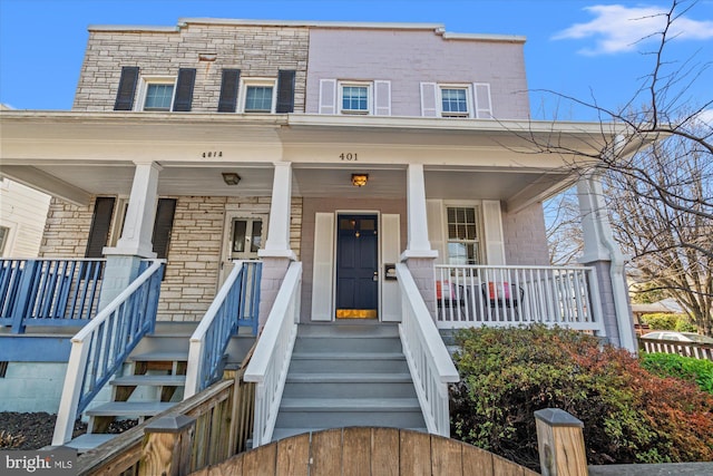 view of front of property with brick siding and a porch