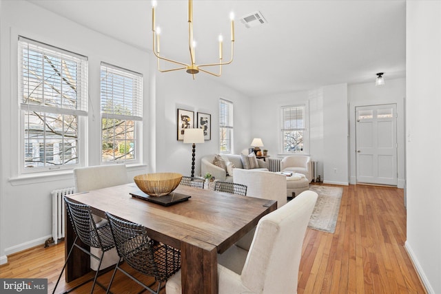 dining area with visible vents, radiator, light wood-type flooring, and baseboards