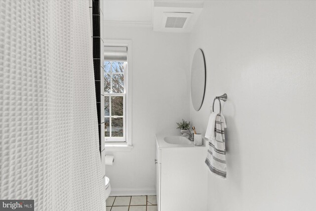 bathroom featuring tile patterned floors, toilet, crown molding, baseboards, and vanity