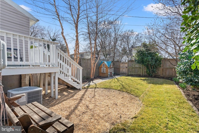 view of yard with a gate, a fenced backyard, cooling unit, stairway, and a wooden deck