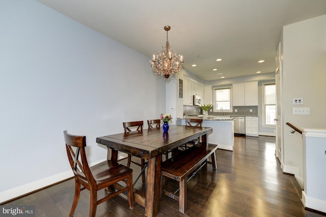 dining room with recessed lighting, baseboards, a notable chandelier, and dark wood-style floors