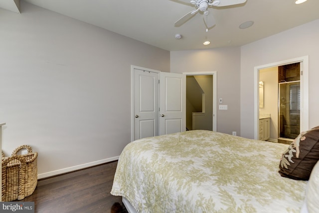 bedroom with dark wood finished floors, ensuite bath, baseboards, and ceiling fan