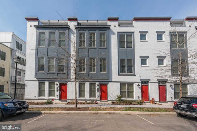 view of building exterior with uncovered parking