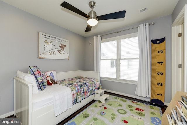 bedroom featuring a ceiling fan and baseboards