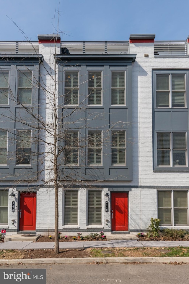 view of property featuring brick siding