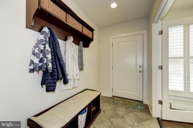 mudroom with a wealth of natural light, baseboards, recessed lighting, and tile patterned flooring