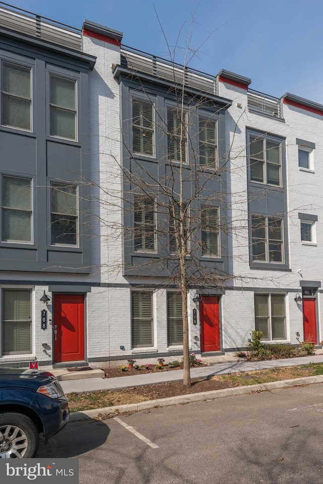 townhome / multi-family property with brick siding