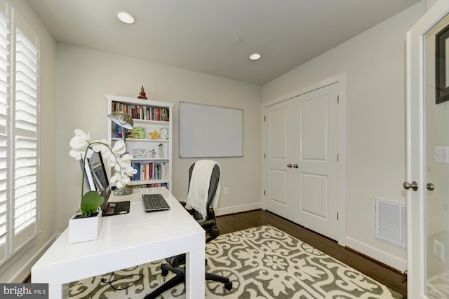 office space featuring recessed lighting, visible vents, baseboards, and dark wood-style floors